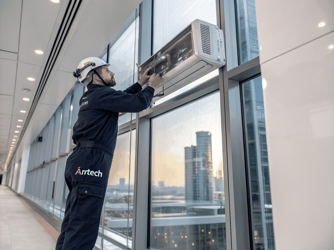 Professional technician servicing air conditioning in a Central Area high-rise apartment